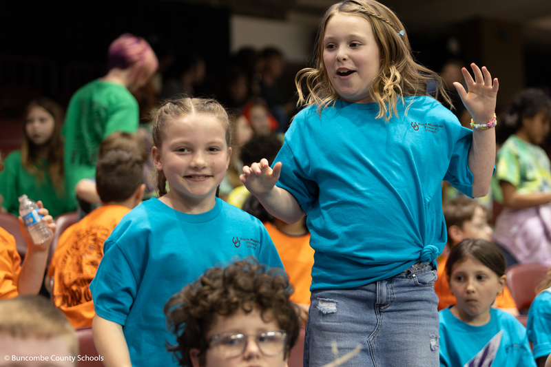 Two students jumping up and down.