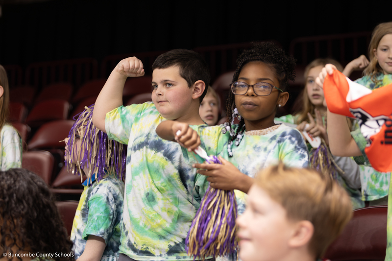 Students showing of muscles for the camera.