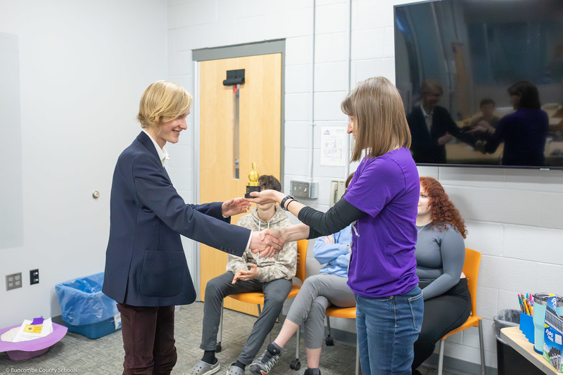 Misti McDaniel hands the trophy to Garrett Armstrong.