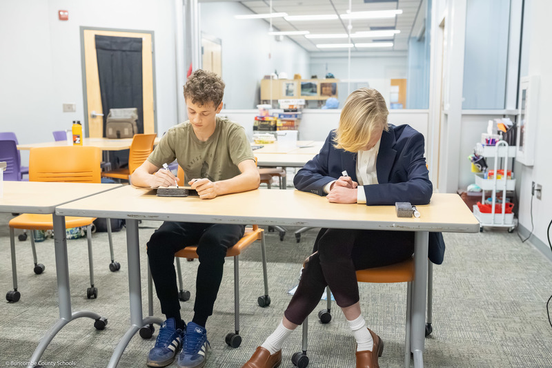 Boone Bowman and Garrett Armstrong write answers to a question.