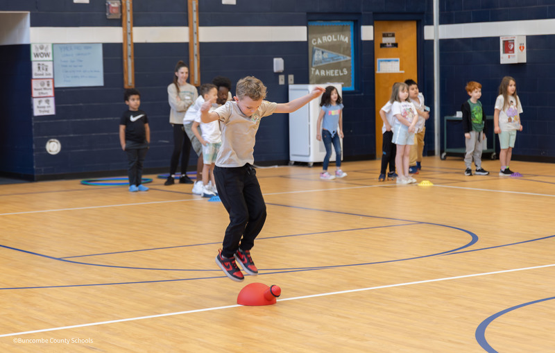 Student jumping on ball launcher