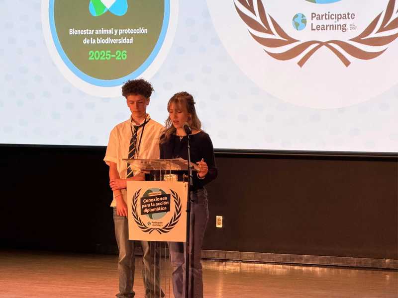 Two students on stage present to the crowd.