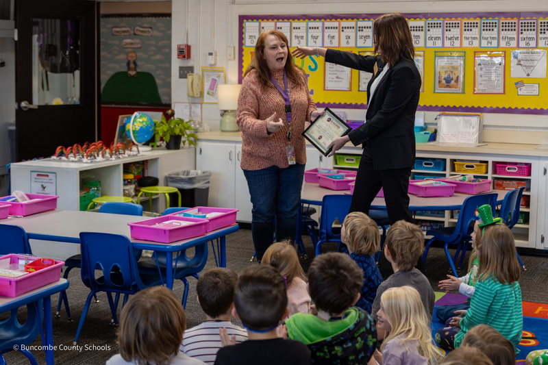 Mrs. McBride is standing in front of the kindergarten class preparing to hug Dr. Jamie Johnson