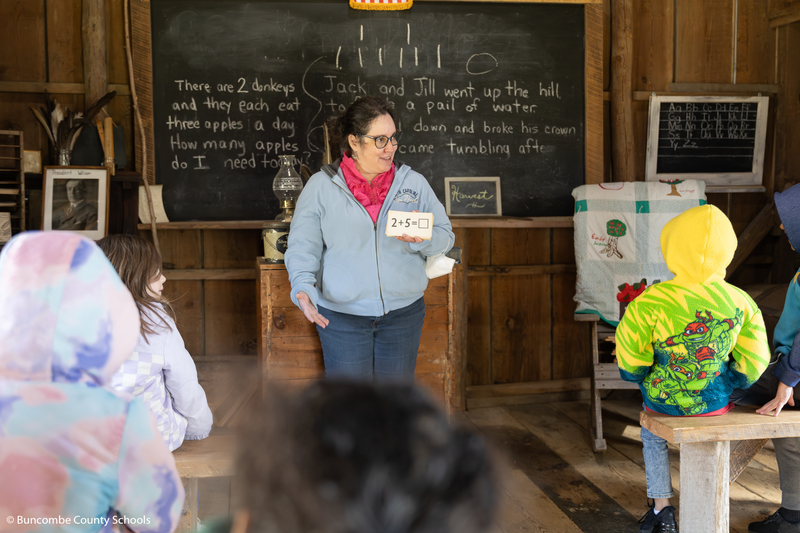 Students learning that students learned math in the 1800s from flash cards in a one room schoolhouse.