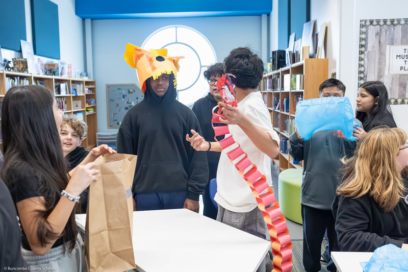 Students trade items with one another, creating a hustle and bustle of tables resembling a marketplace.