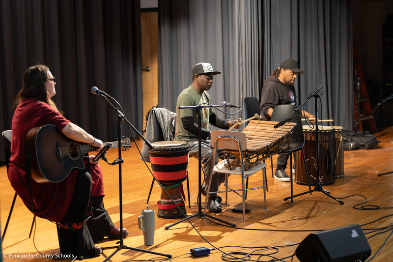 The KONO band on stage performing for students and staff. 