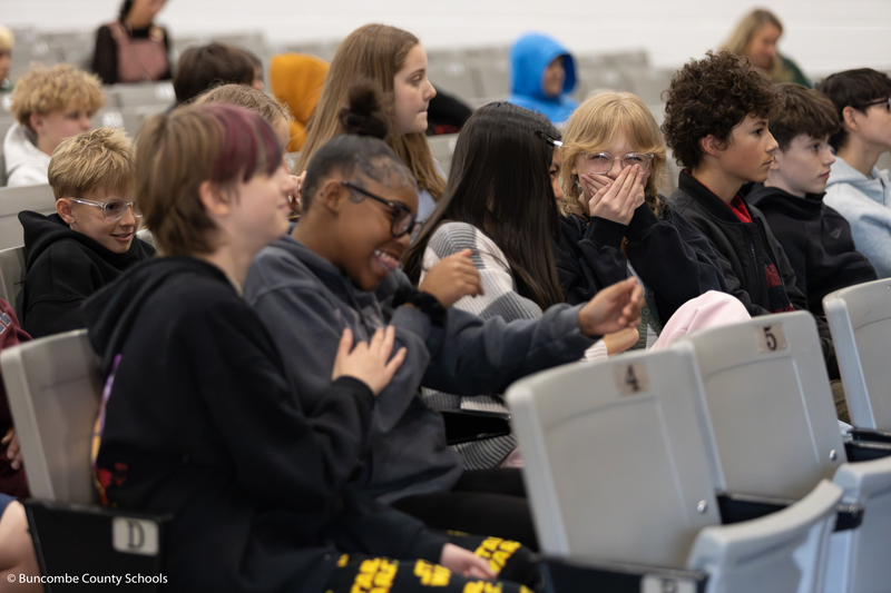 Students dancing and laughing to the music. 