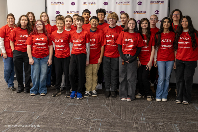 The Erwin Middle MathCounts team poses for a photo in front of the Buncombe County Schools banner.