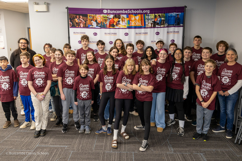 The Owen Middle School MathCounts team poses for a photo in front of the Buncombe County Schools banner.