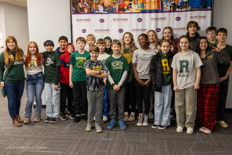 The Reynolds Middle School MathCounts team poses for a photo in front of the Buncombe County Schools banner.