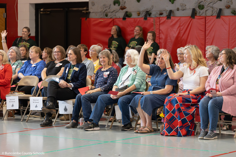 Mrs. Gortney and Mrs. Cheatham raise their hands while seated.