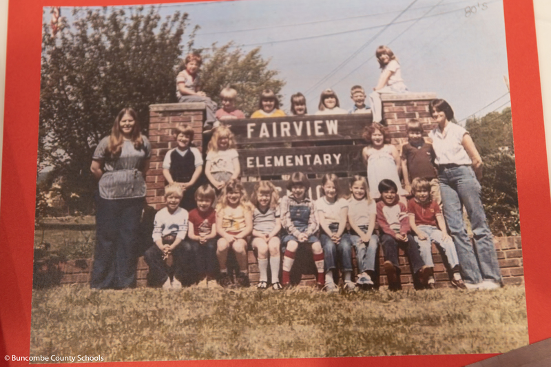 A vintage photo of students surrounding the old Fairview Elementary sign.
