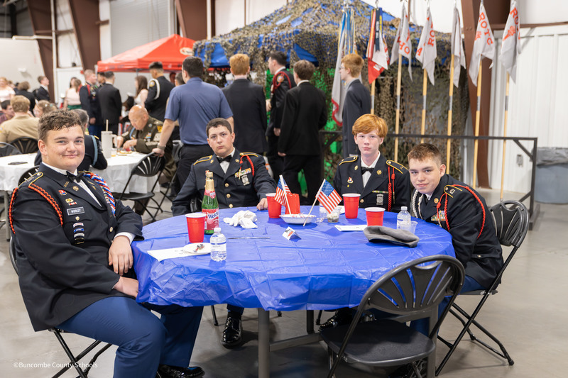 Students sitting at table smiling