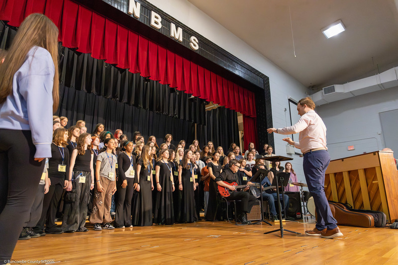Middle School All-County Chorus members practice before the performance.