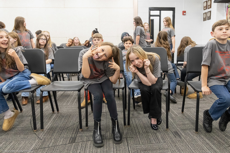 Two elementary/intermediate students make a silly pose for the camera.