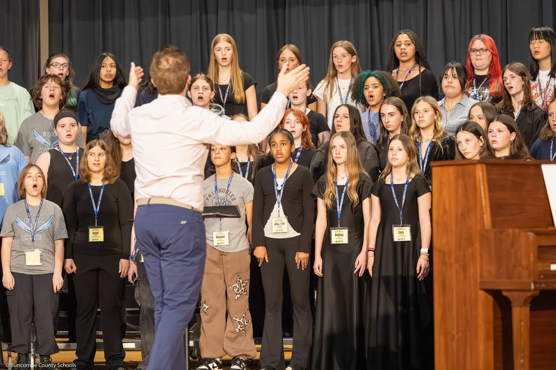Middle School All-County Chorus members practice before the performance.