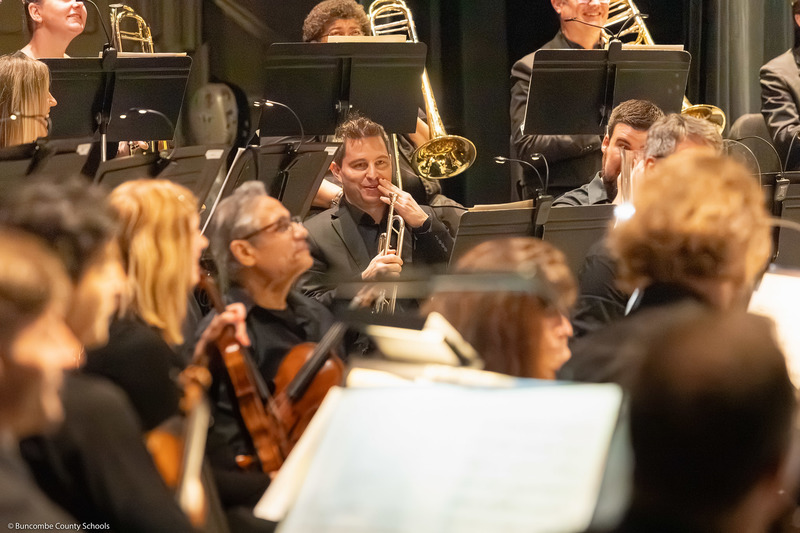 A trumpet player smiles during the performance.