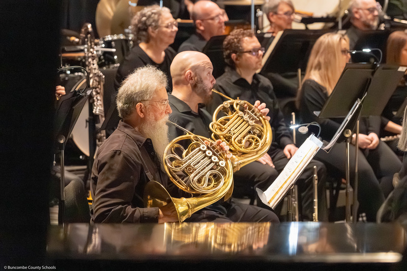 French horn players perform.