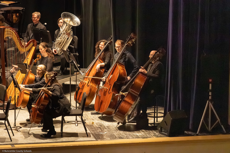 Cellists play their instruments.