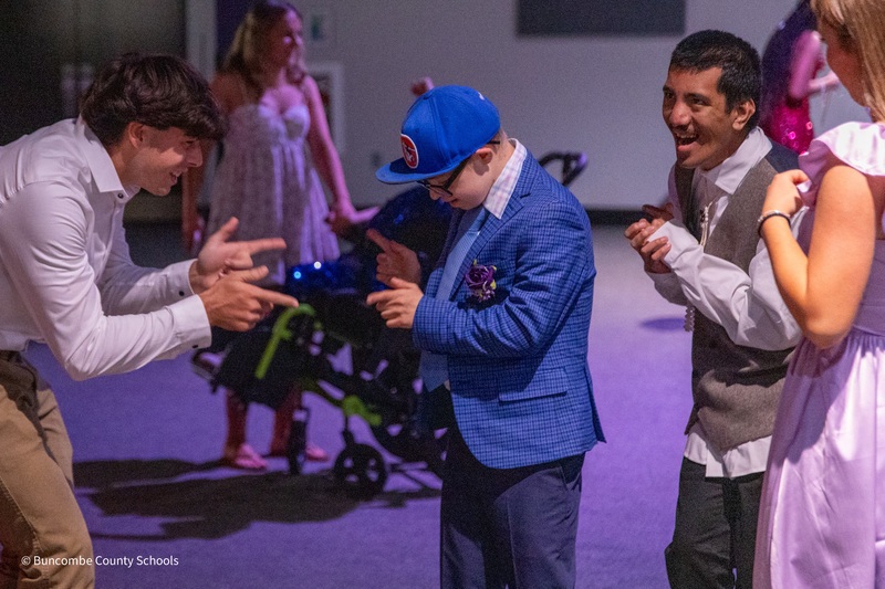A peer tutor dances with a PEP student.