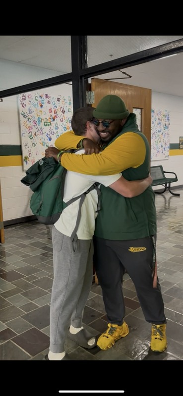 Baseball senior hugging a coach who made a difference. 