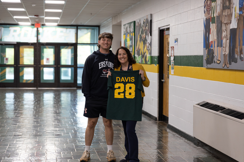 Baseball senior with a school counselor who received an impact shirt. 
