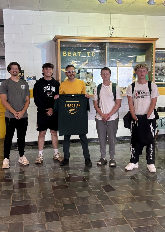 The baseball seniors with Principal Ben Alexander who received an impact shirt. 