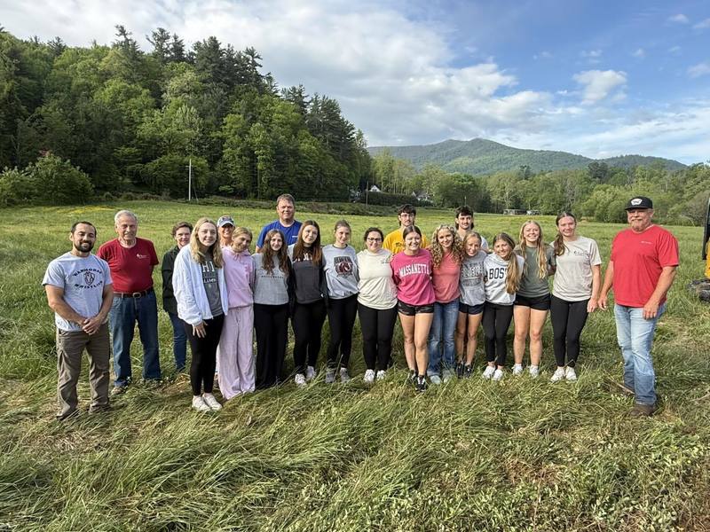 Students pose for a group photo on the land they have cleaned up.