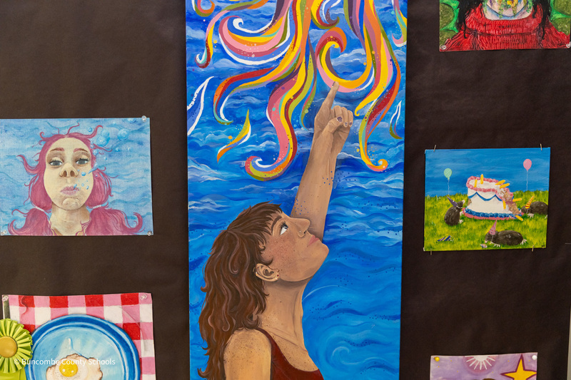 A collage of paintings created by high school students.