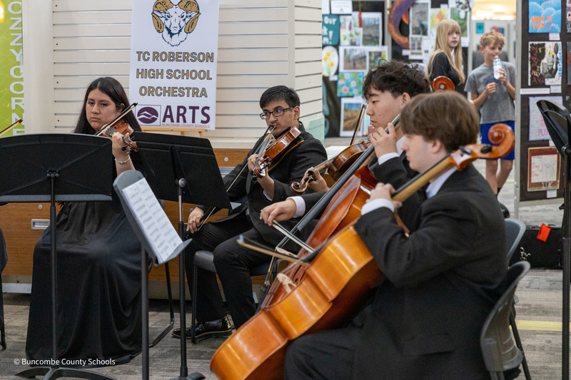 The T.C. Roberson orchestra performs in Asheville Mall.