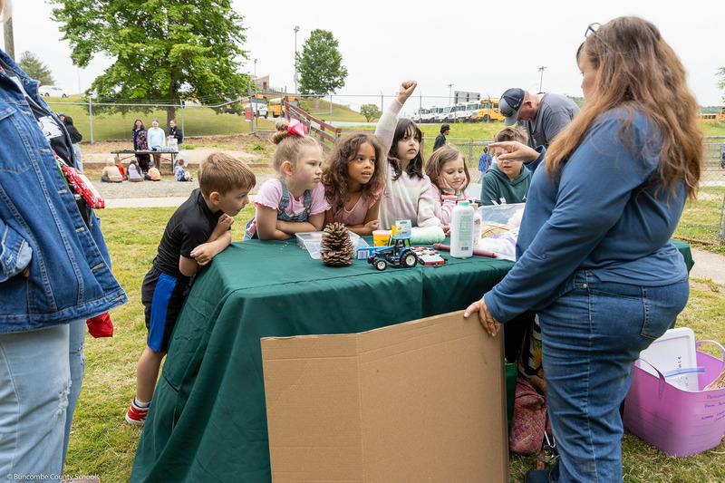 Students work on an activity at a folding table.