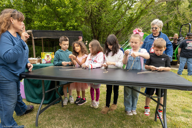 Students work on an activity at a folding table.