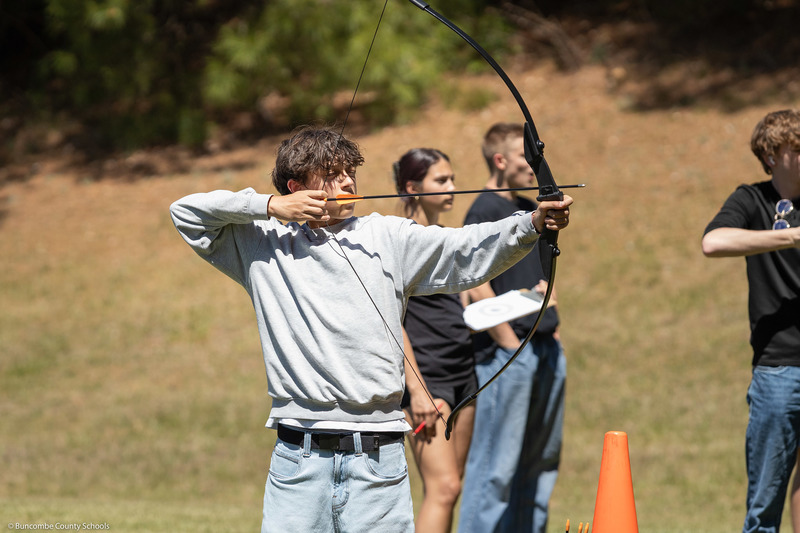 A student aims at the target.