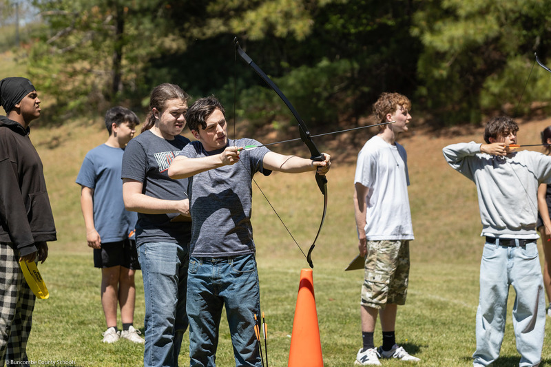 A student aims at the target.
