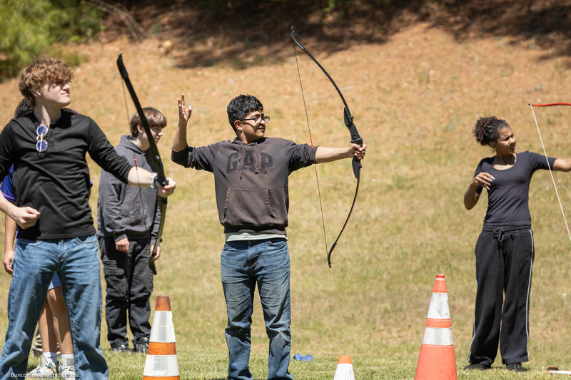 A student aims at the target.