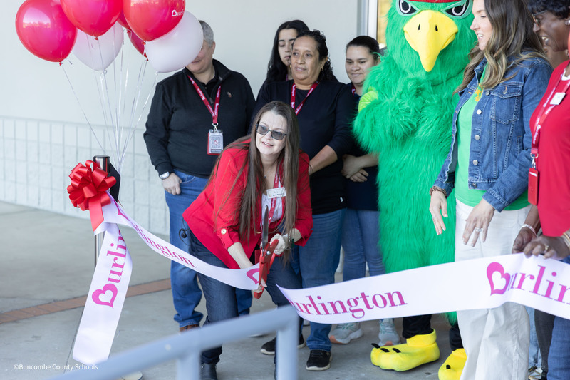 A Burlington employee cuts the ribbon to open the store.