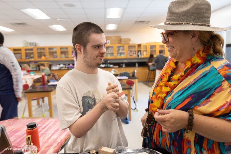 Heather Ross helping student smell perfume