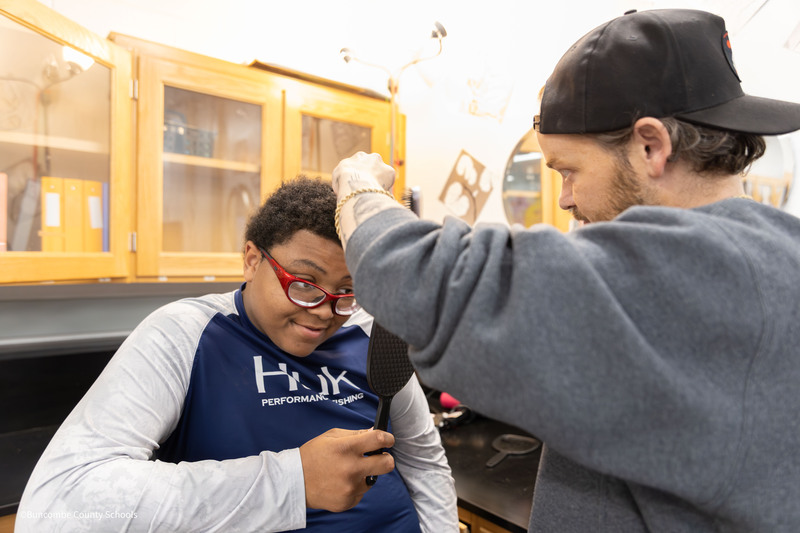 Tyler styling student's hair