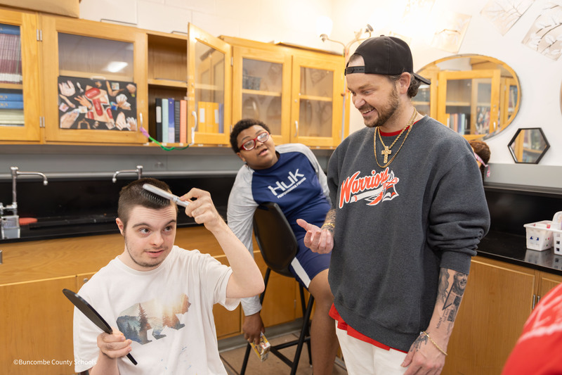 Tyler helping students style hair
