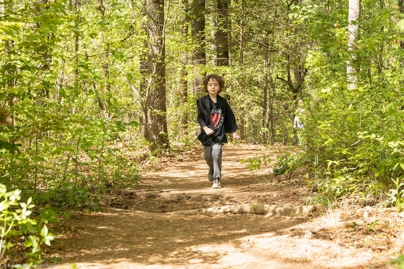A girl walks down a trail.