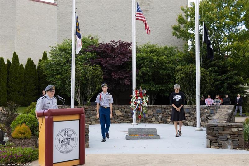 ROTC students standing at flag pole and podium