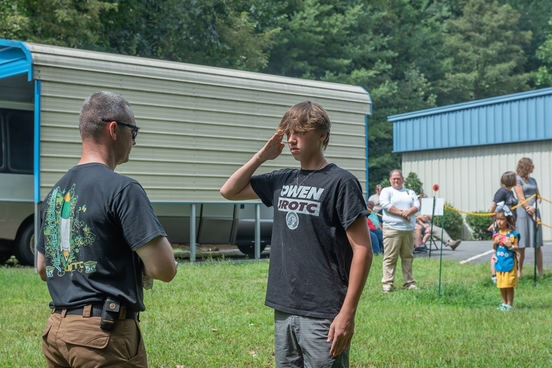 Student saluting the flag.