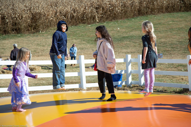Students jumping at the Eliada Home Corn Maze
