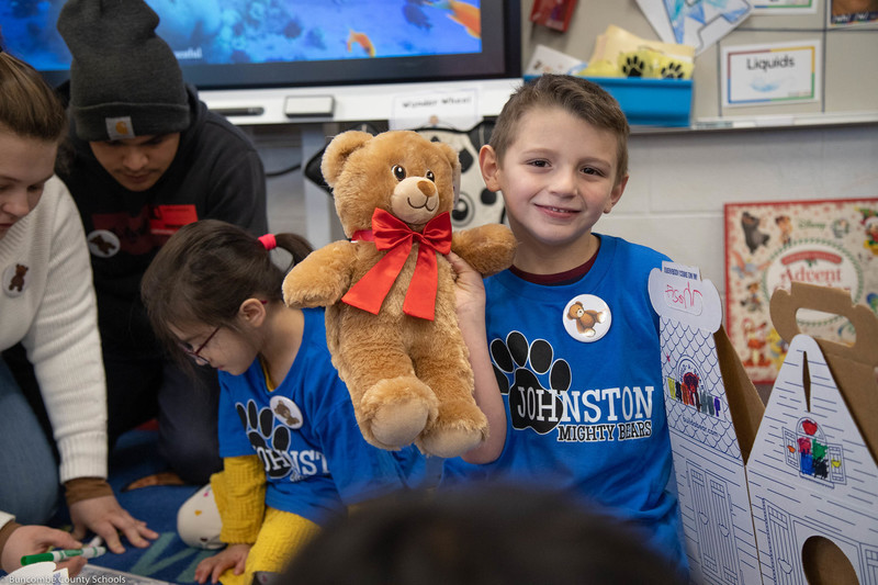 Student holding his bear.