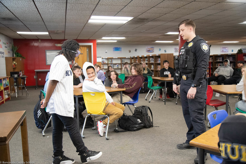 Student trying to balance on one leg while wearing the drinking simulation goggles.
