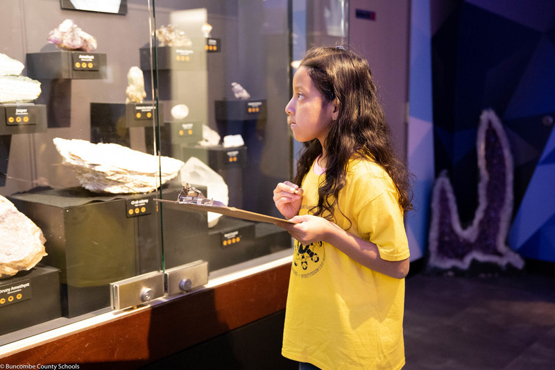 Student doing a gem scavenger hunt. 