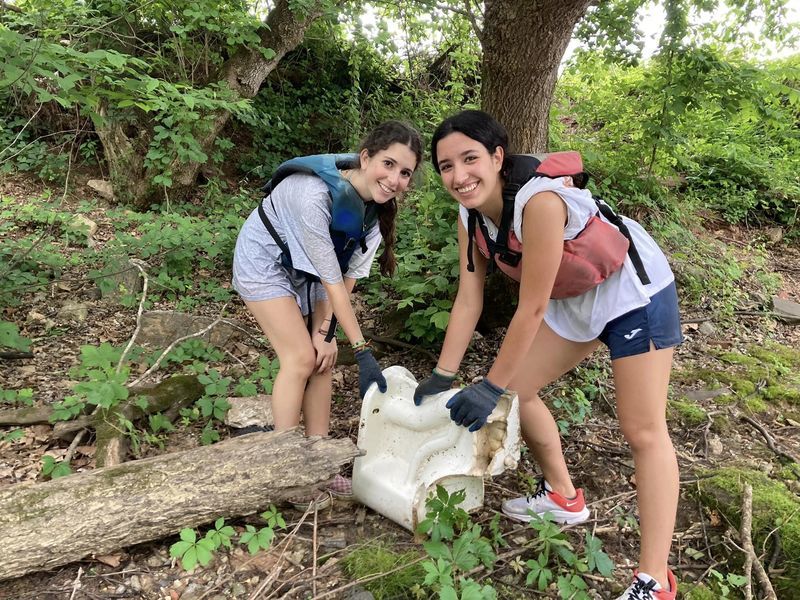 Students removing debris from the river bank. 