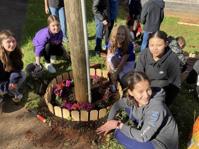Students planting flowers. 