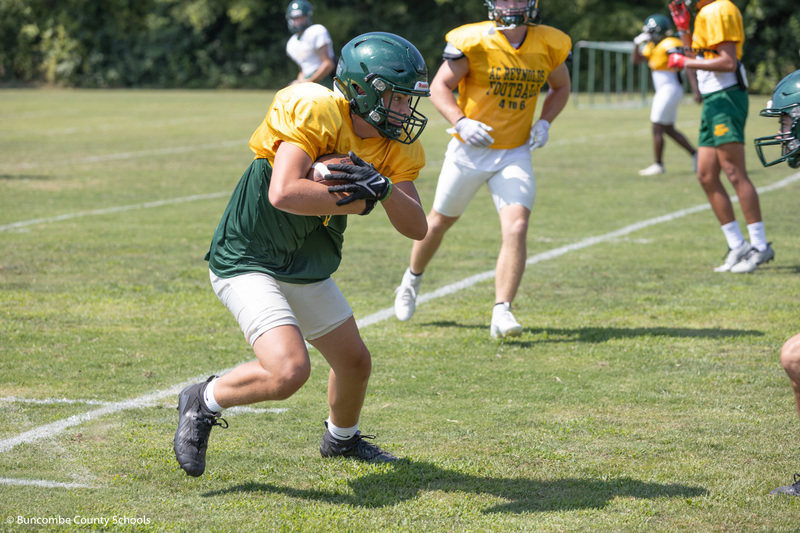 Football player working on plays at practice. 