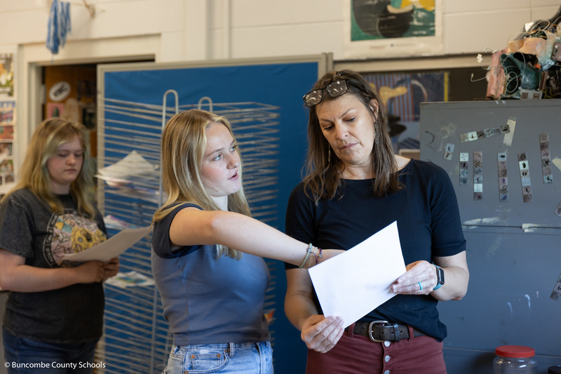 Ms. Hambright helping a student with a project.